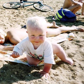 Family enjoying outdoor beach day with sunbathing and play.