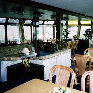 Luxurious indoor dining and lounge area on a cruise ship.