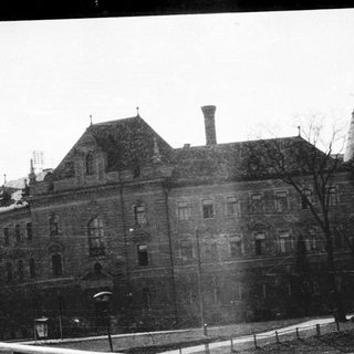 Historic building with steep roofs, snow-covered, winter scene.
