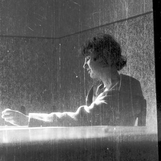 Woman playing piano under cascading water.