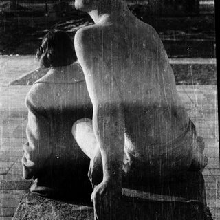 Sculpture of seated, contemplative nude figure.