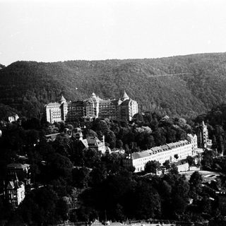 Historic hillside resort with grand buildings.