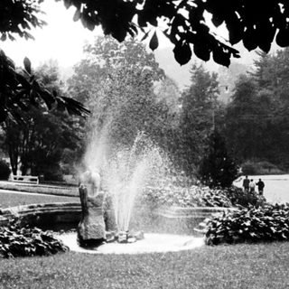 Fire hydrant spraying water in a park.