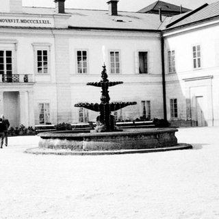 Neoclassical building with Metternich inscription and fountain.