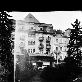 Elegant historic hotel with fountain in foreground.