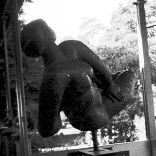 A person mid-air performing a handstand indoors.