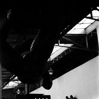 Industrial space with suspended propeller and sculpture.