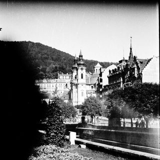 Baroque-style castle complex by waterfront.