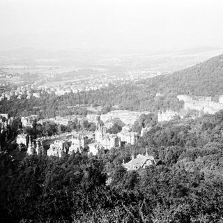 Historic hilltop town nestled in forested valley.