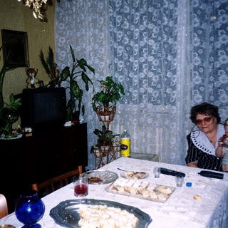 Family enjoying meal indoors with snacks.