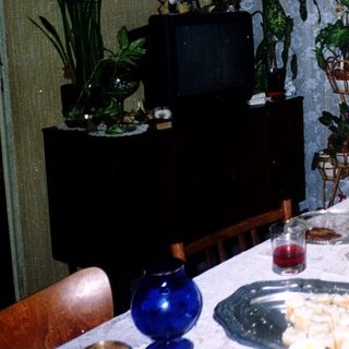 Family enjoying meal indoors with snacks.