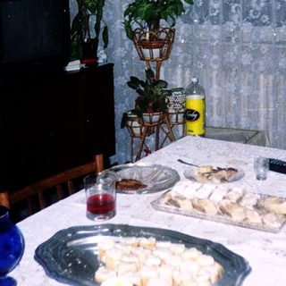 Family enjoying meal indoors with snacks.