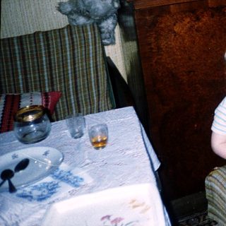 Family enjoying meal indoors with child and adult.