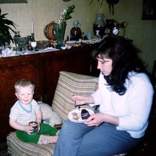 Family enjoying meal indoors with child and adult.