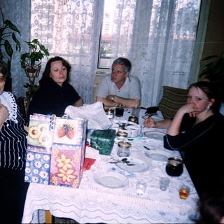 Family gathering around a festively set table.