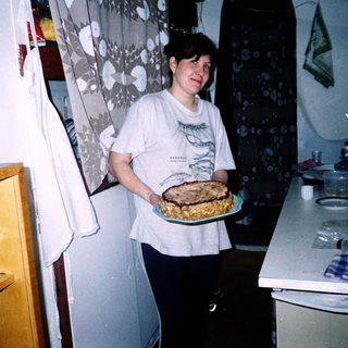 Person holding baked dish in kitchen.
