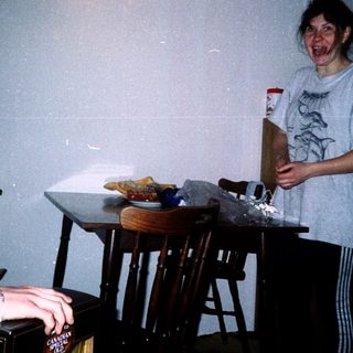 Two people playing video game indoors.