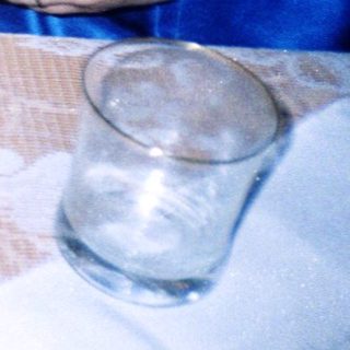 Toddler reaching for food at table.