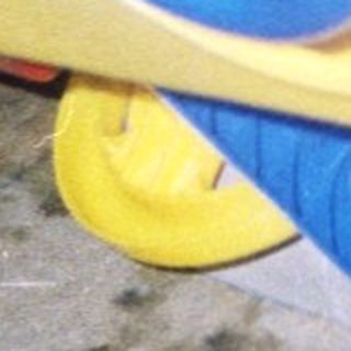 Child playing with yellow and blue toy truck.