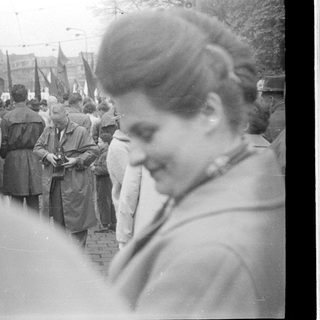 Historical street protest with flag-bearing marchers.