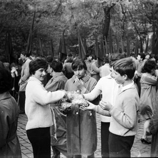 People exchanging wreaths at a memorial gathering.