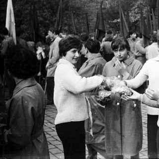 People exchanging wreaths at a memorial gathering.