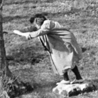Children playing in a grassy outdoor area.