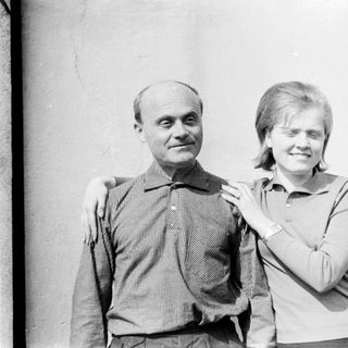 Two people posing together outdoors, smiling.