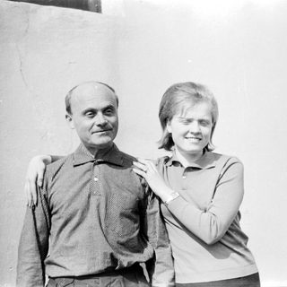 Two people posing together outdoors, smiling.