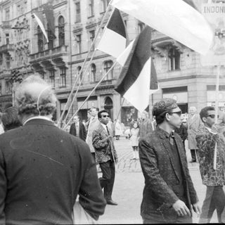 Street protest with flags and crowd.
