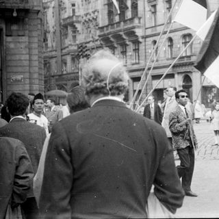 Street protest with flags and crowd.