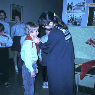 Scout ceremony with leader pinning badge on boy.