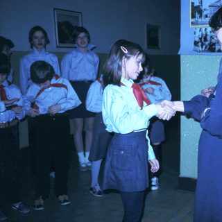 School ceremony with students shaking hands.
