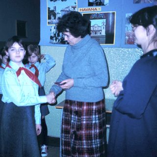 Girl scout handshake ceremony with adult leader.