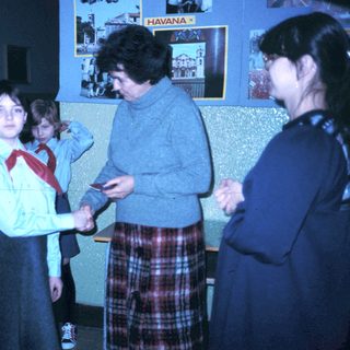 Girl scout handshake ceremony with adult leader.