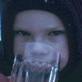 Child holding hot drink in winter snow.