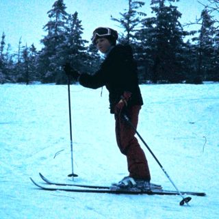 Person skiing on snow-covered slope.