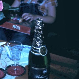 Family celebrating birthday indoors with cake and gifts.