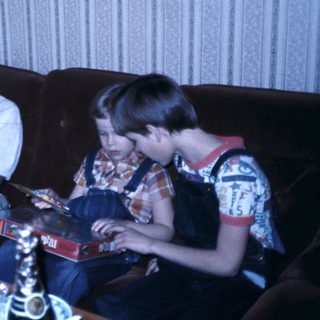 Family gathering reading books indoors.