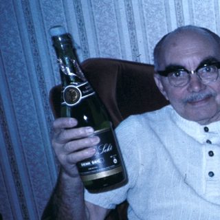 Family enjoying drinks and celebration indoors.