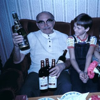 Family enjoying drinks and celebration indoors.