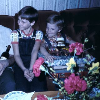 Family enjoying drinks and celebration indoors.