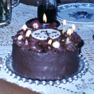 Child blowing out birthday cake candles.