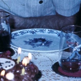 Child blowing out birthday cake candles.
