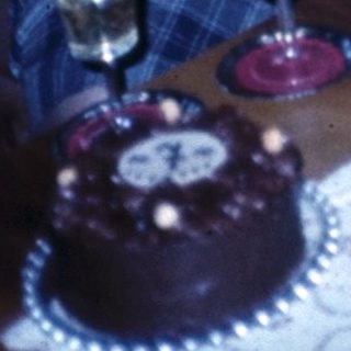 Two elderly people celebrating with cakes indoors.
