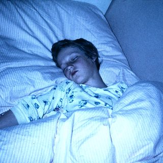 A person sleeping peacefully in a hospital bed.