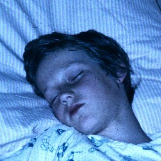 A person sleeping peacefully in a hospital bed.