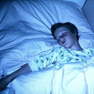 A person sleeping peacefully in a hospital bed.
