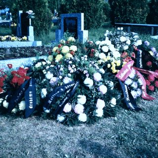 Memorial grave adorned with floral tributes.