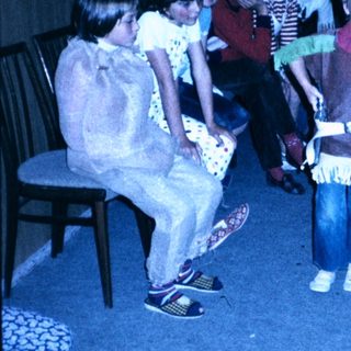 Children dressed in costumes playing indoors.